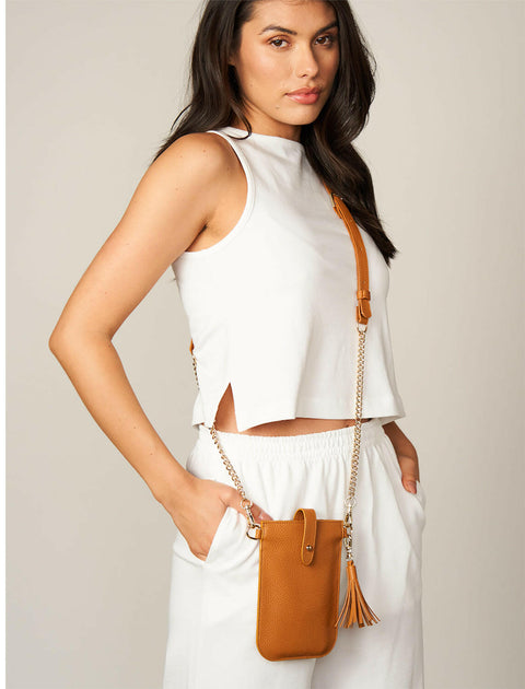 a woman wearing a tan leather stylish crossbody Phone Bag 