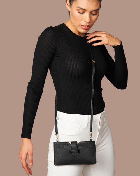 woman wearing a black crossbody bag for her phone 
